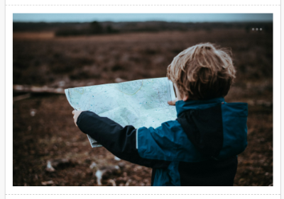 An Unsplash photograph added to a Document (showing a boy looking at a map)